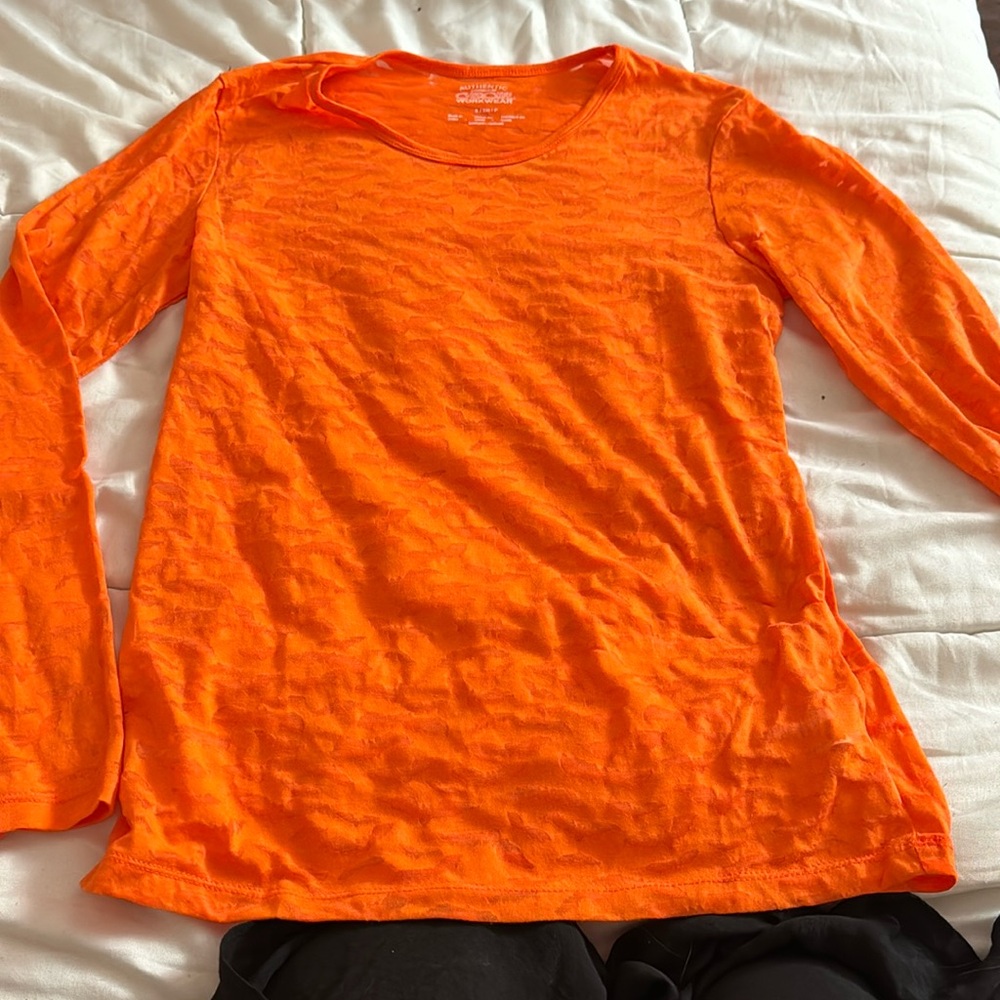 it’s a very vibrant orange with cute bats for halloween
